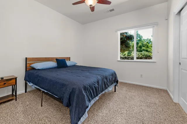 a bedroom with a bed and window