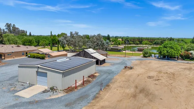 an aerial view of a house with a big yard