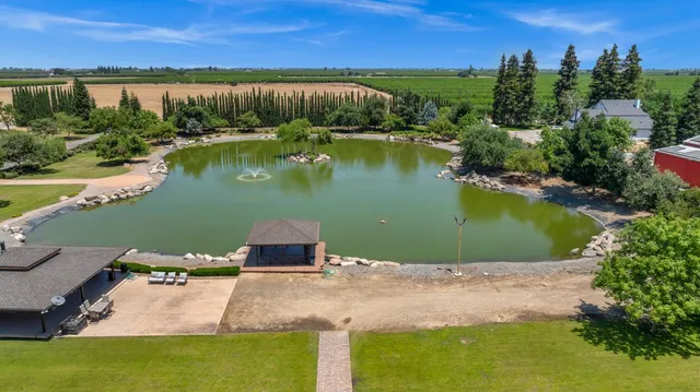 an aerial view of a house with a yard lake view and mountain view