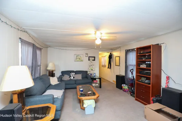 a living room with furniture and a lamp