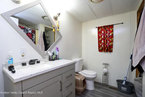 a bathroom with a sink toilet and a mirror
