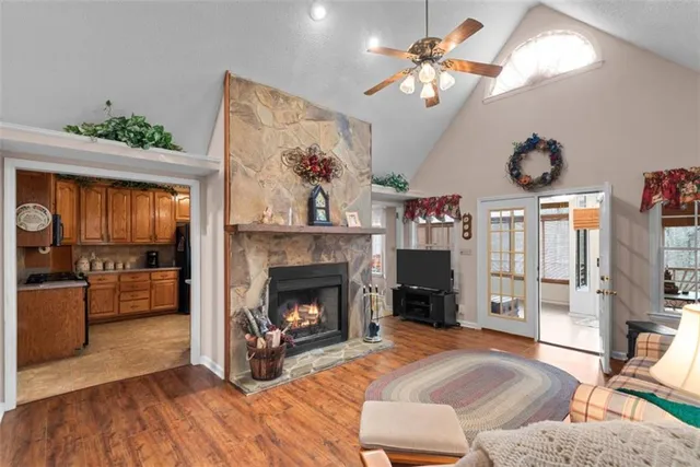a spacious bedroom with a bed a dresser next to a window