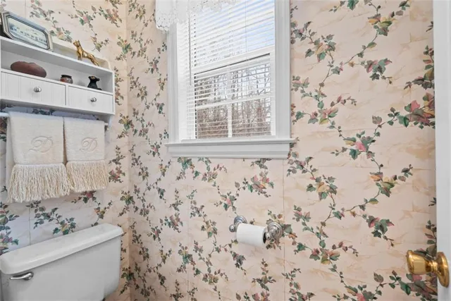 a bathroom with a sink a toilet and shower curtain