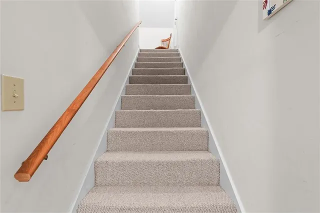 a bathroom with a granite countertop toilet a sink a shower and a mirror