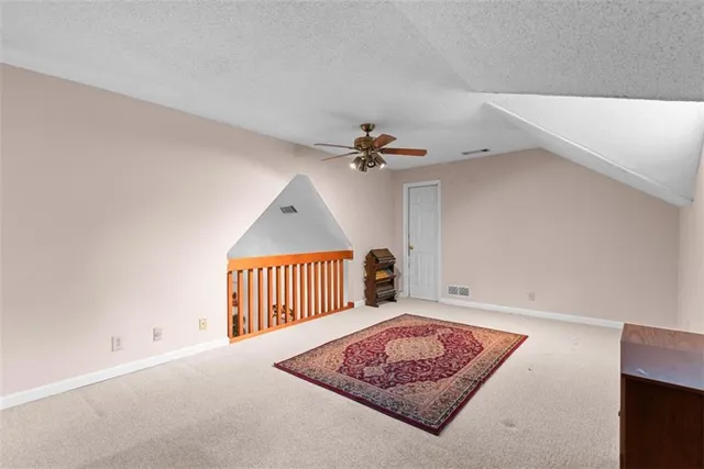 a view of a chairs and table in the back yard of the house