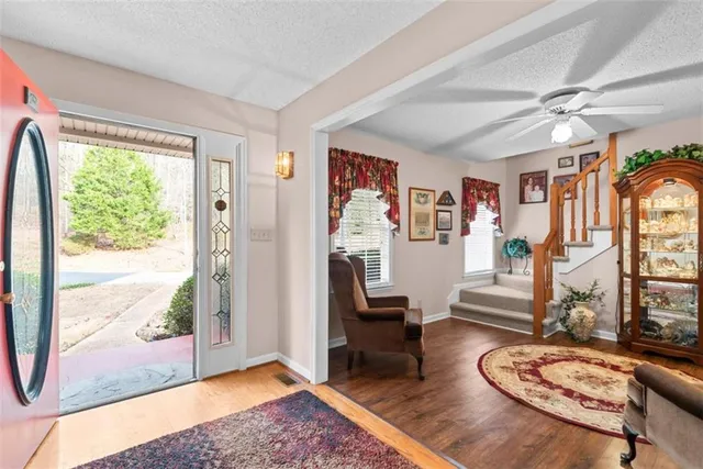 a living room with chair and a window