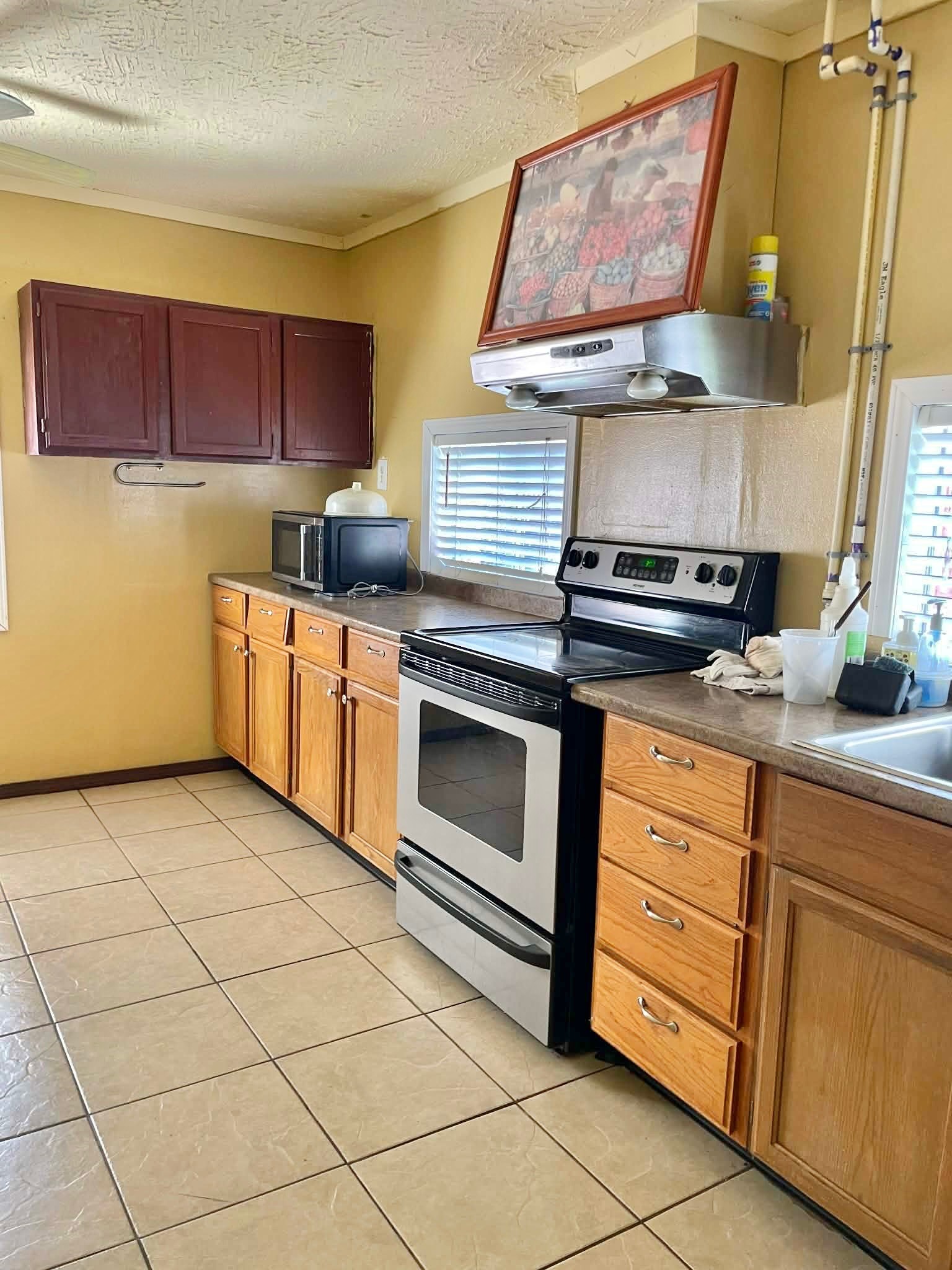 1825 Isom Street Houston, TX 77039 - Photo 17 of 27 a kitchen with stainless steel appliances granite countertop a stove a sink and a microwave