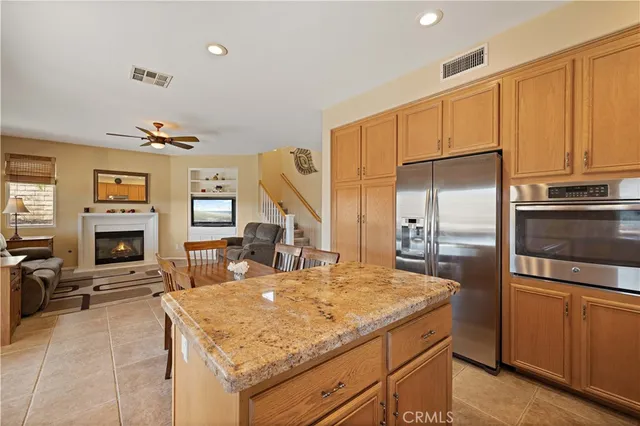 a kitchen with stainless steel appliances granite countertop a sink a stove and a microwave