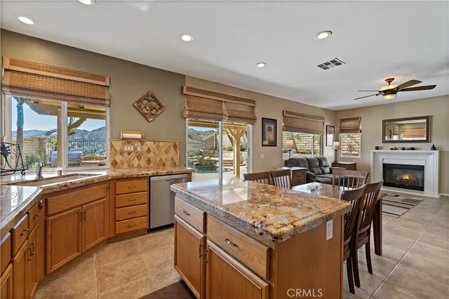 a bathroom with a granite countertop sink toilet and a large mirror