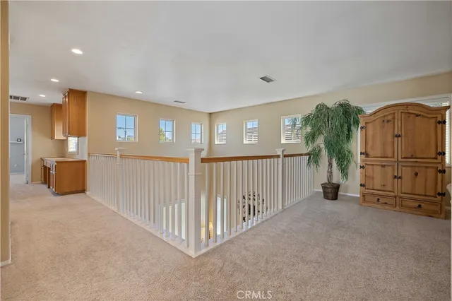 a bedroom with a bed and a flat tv screen on dresser