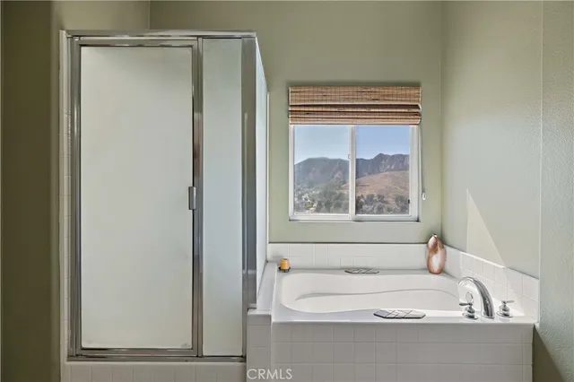 a bedroom with a bed and a ceiling fan