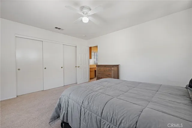a view of a patio with couches table and chairs and potted plants