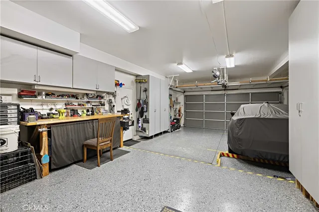 a aerial view of a house with a yard and large tree