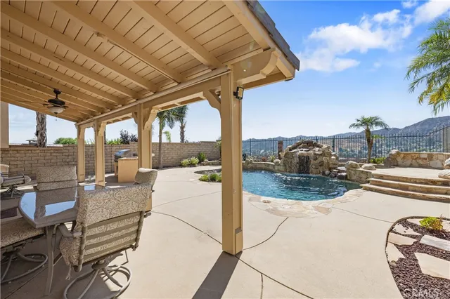 a view of a swimming pool with a table and chairs