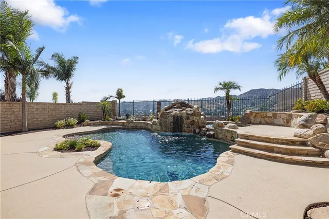 a view of a swimming pool with a yard