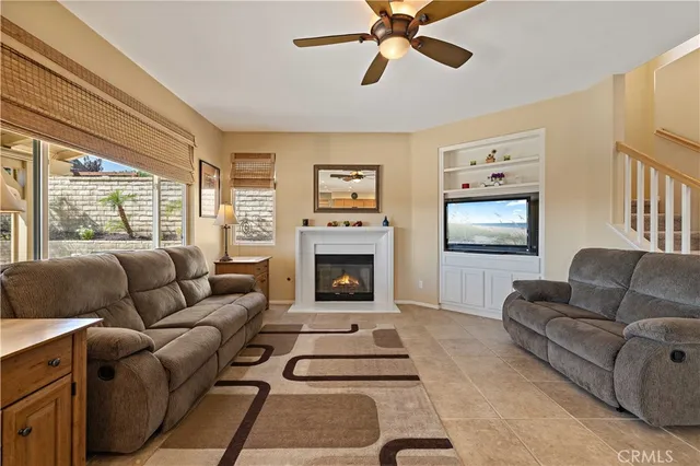 a living room with furniture a window and a fireplace