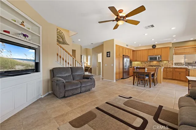 a living room with furniture and kitchen view