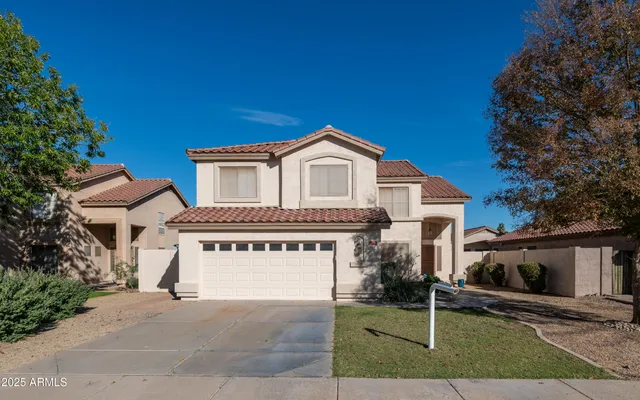 a view of a house with a yard and garage