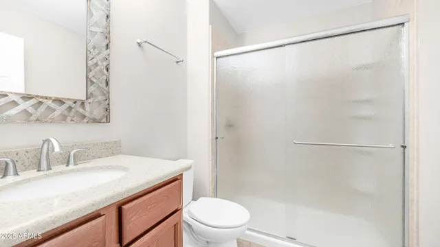 a view of a hallway with white walls and chandelier