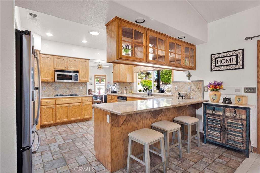 19985 Red Feather Road Apple Valley, CA 92307 - Photo 14 of 56 a kitchen with a sink cabinets and window
