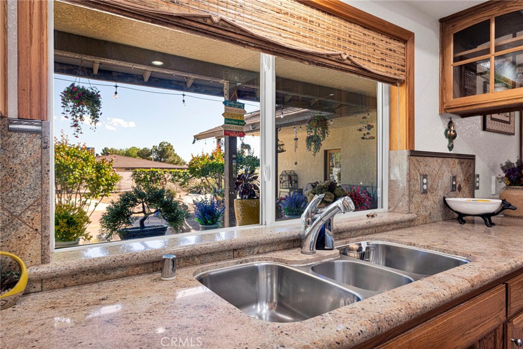 19985 Red Feather Road Apple Valley, CA 92307 - Photo 15 of 56 a view of a kitchen with a sink and a large window