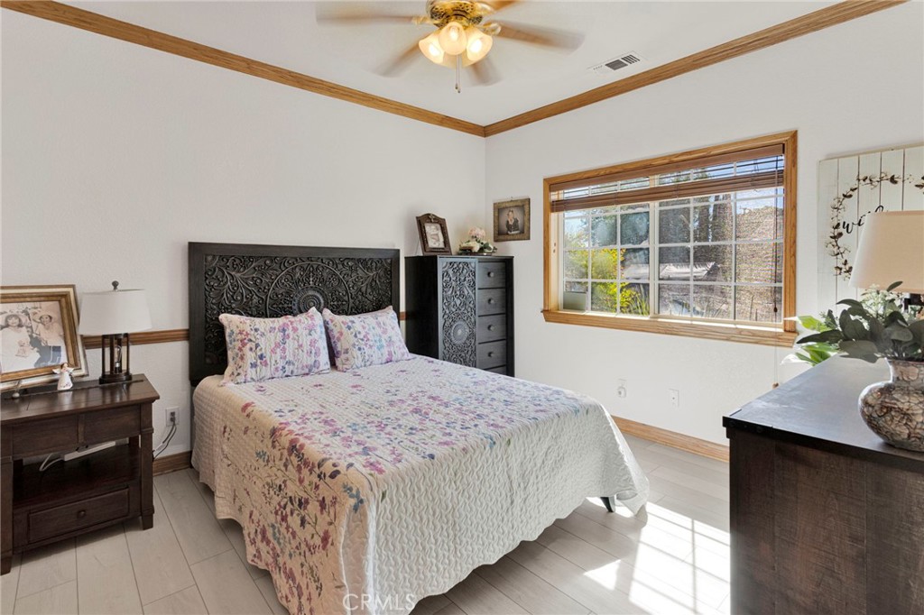 19985 Red Feather Road Apple Valley, CA 92307 - Photo 20 of 56 a bedroom with bed and a potted plant