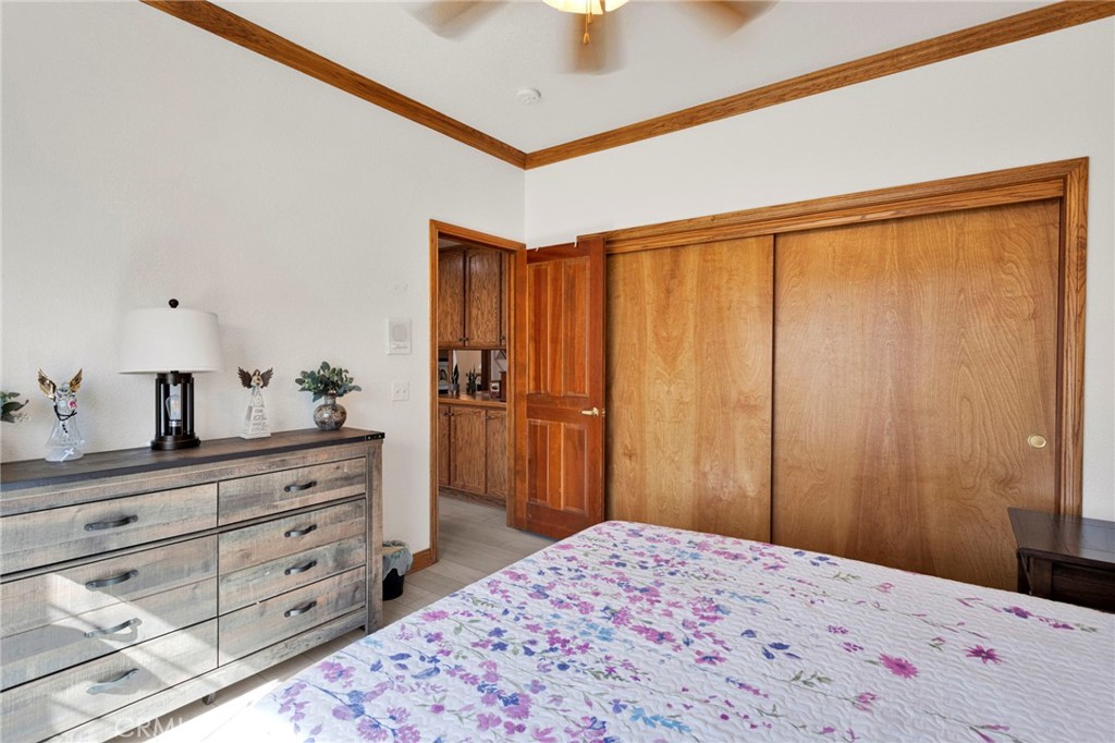 19985 Red Feather Road Apple Valley, CA 92307 - Photo 21 of 56 a bedroom with a bed and a dresser in it