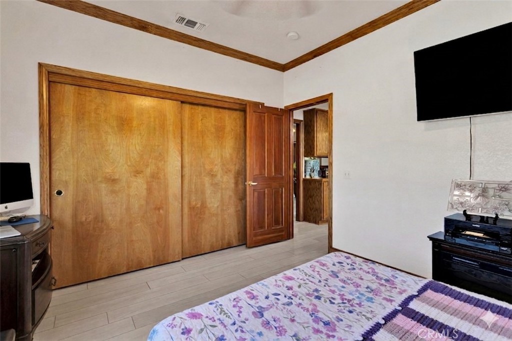 19985 Red Feather Road Apple Valley, CA 92307 - Photo 24 of 56 a bedroom with a bed and flat screen tv