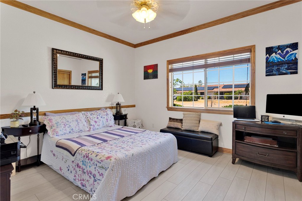 19985 Red Feather Road Apple Valley, CA 92307 - Photo 25 of 56 a bedroom with a bed and a flat screen tv