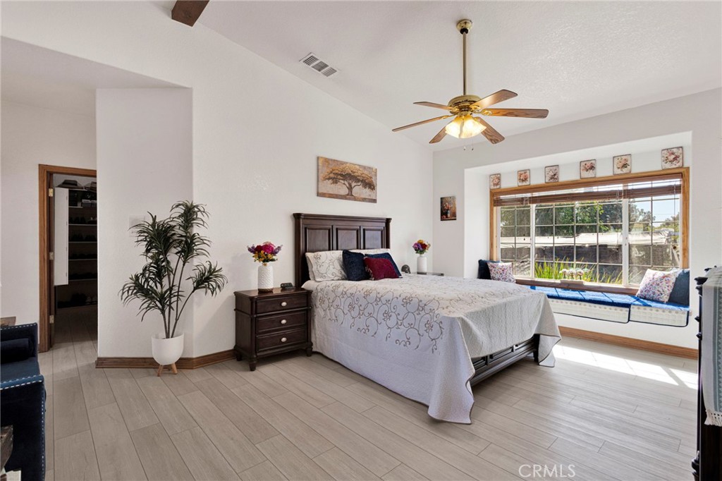 19985 Red Feather Road Apple Valley, CA 92307 - Photo 27 of 56 a spacious bedroom with a large bed and a chandelier