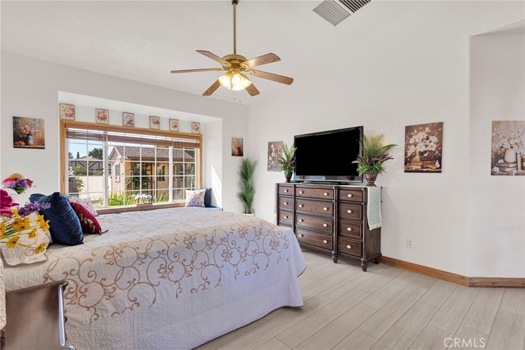 19985 Red Feather Road Apple Valley, CA 92307 - Photo 28 of 56 a bedroom with a bed and a flat tv screen on dresser