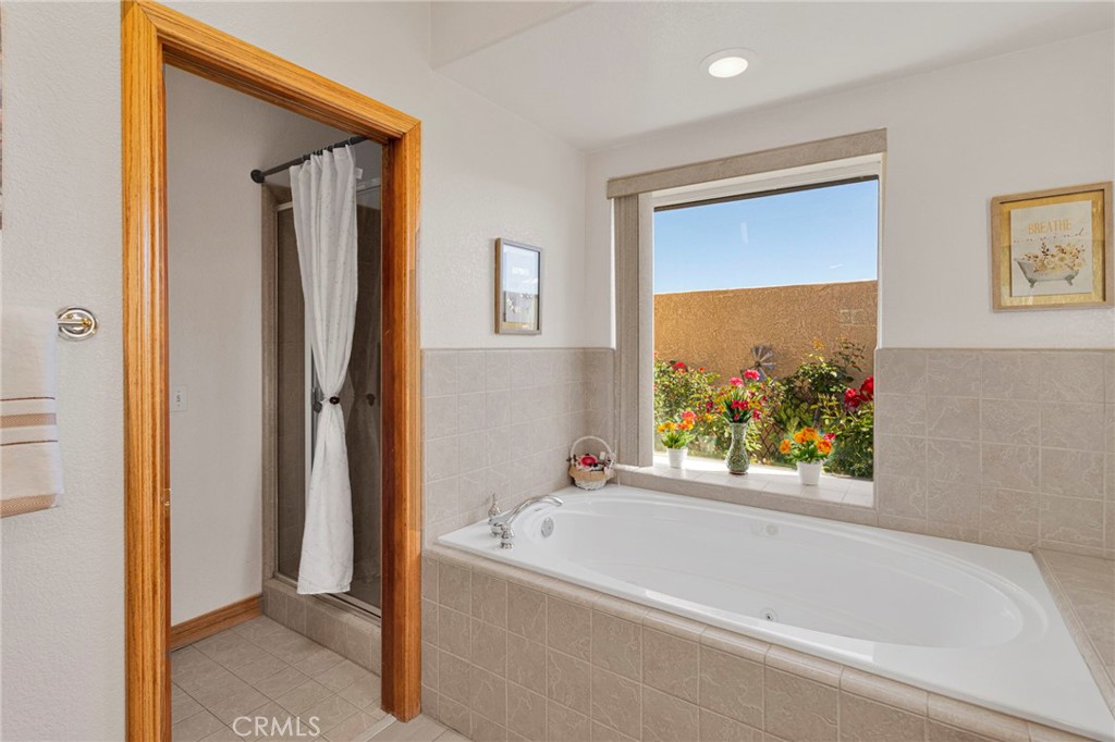 19985 Red Feather Road Apple Valley, CA 92307 - Photo 32 of 56 a bathroom with a bathtub and a shower