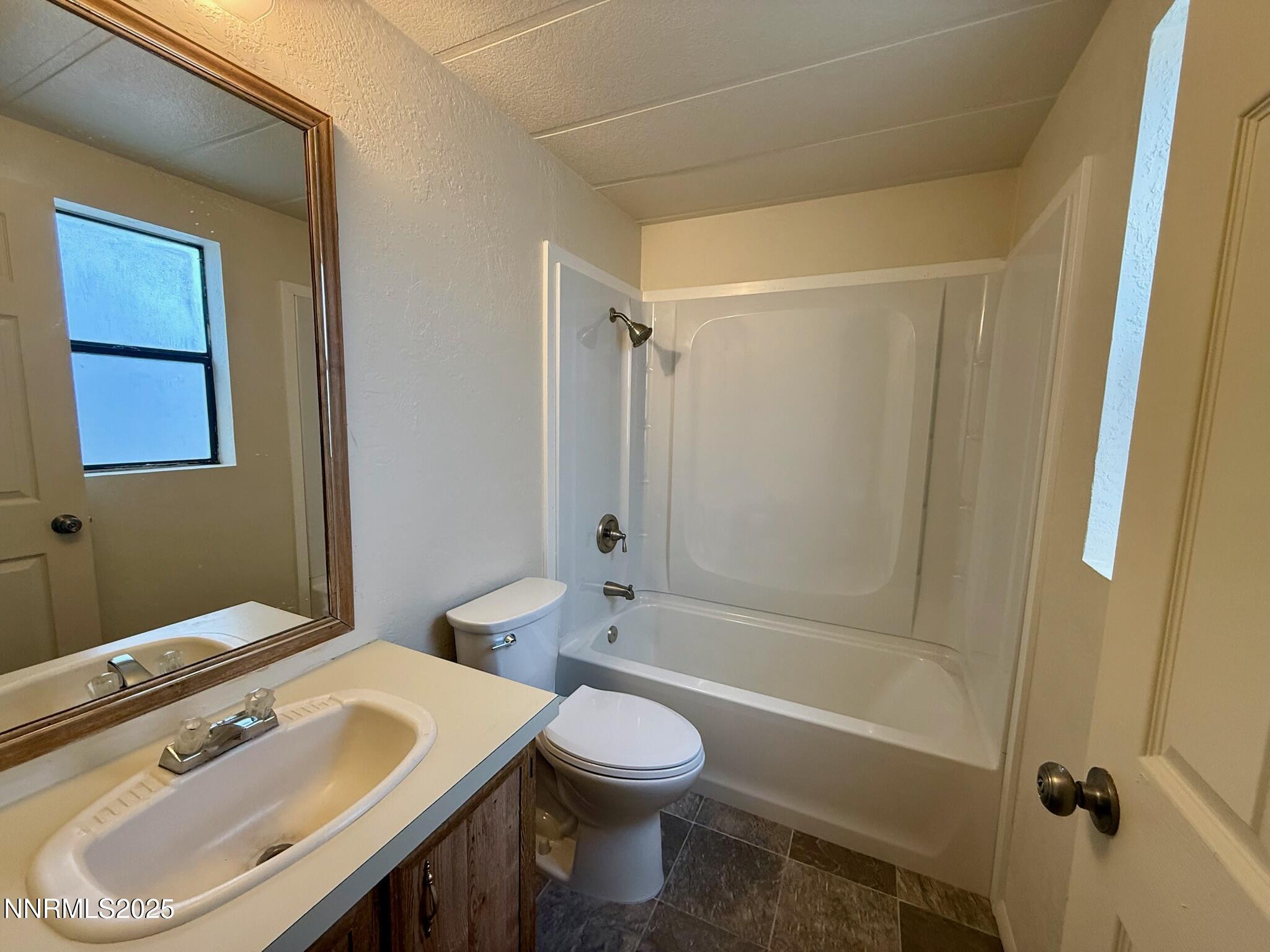 305 Kimble Drive Spring Creek, NV 89815 - Photo 25 of 31 a bathroom with a sink toilet and shower
