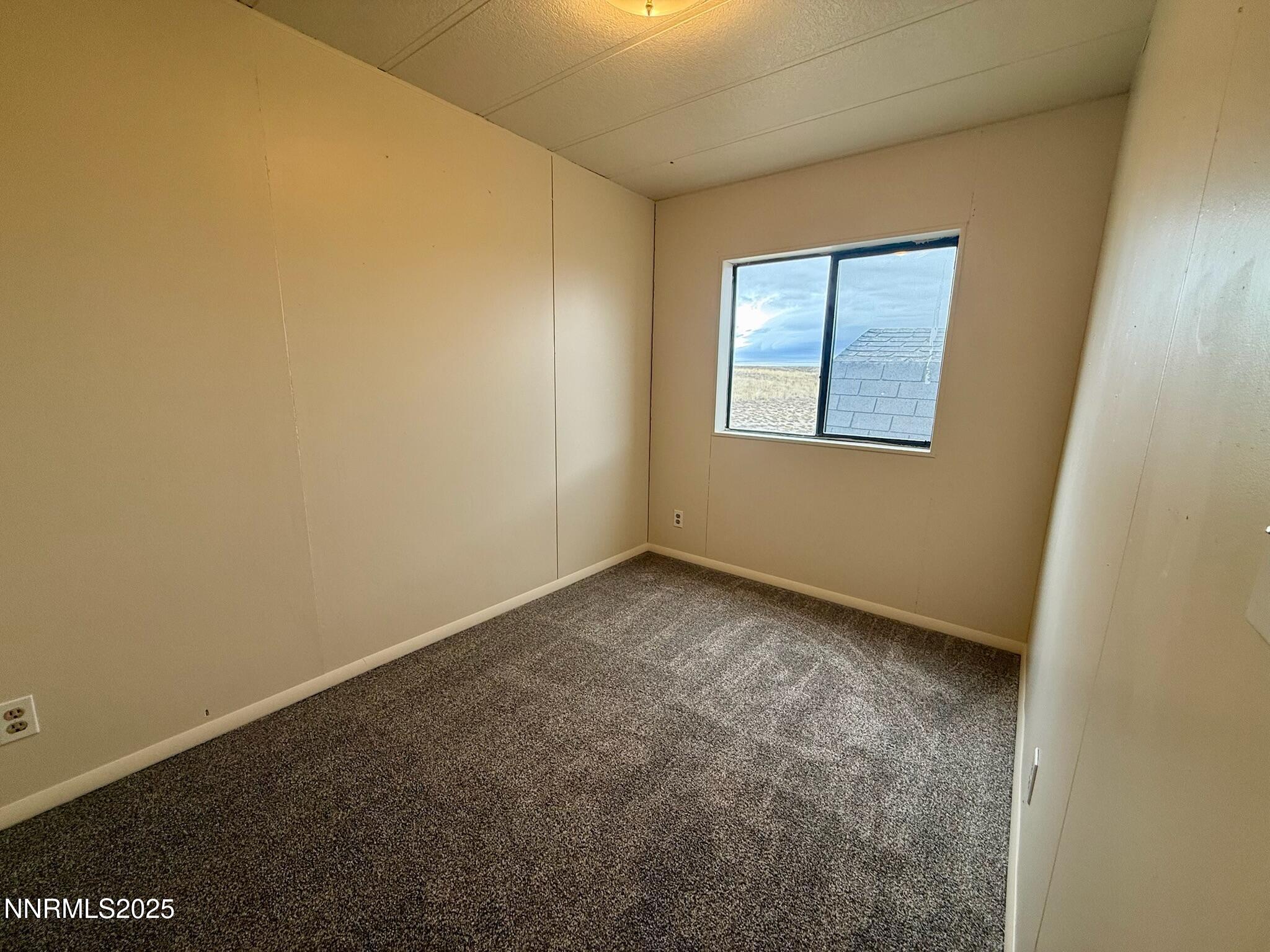 305 Kimble Drive Spring Creek, NV 89815 - Photo 26 of 31 an empty room with a window