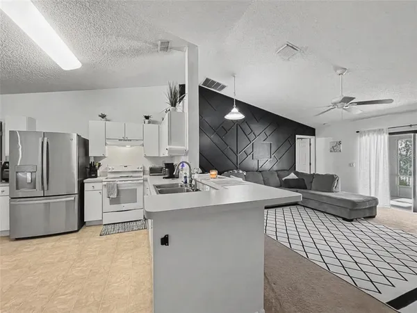 a kitchen with refrigerator cabinets and a counter top space