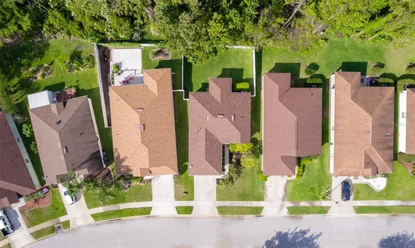 an aerial view of a house with a yard and garden