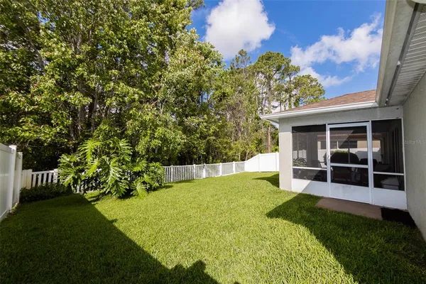 a view of a backyard with a garden and deck