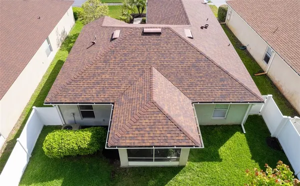 an aerial view of a house with a yard