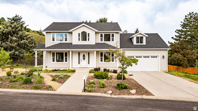 1552 Sumac Drive Logan, UT 84321 - Photo 71 of 72 Two-story residence featuring light-colored siding, a dark shingle roof, and a prominent arched window on the upper level