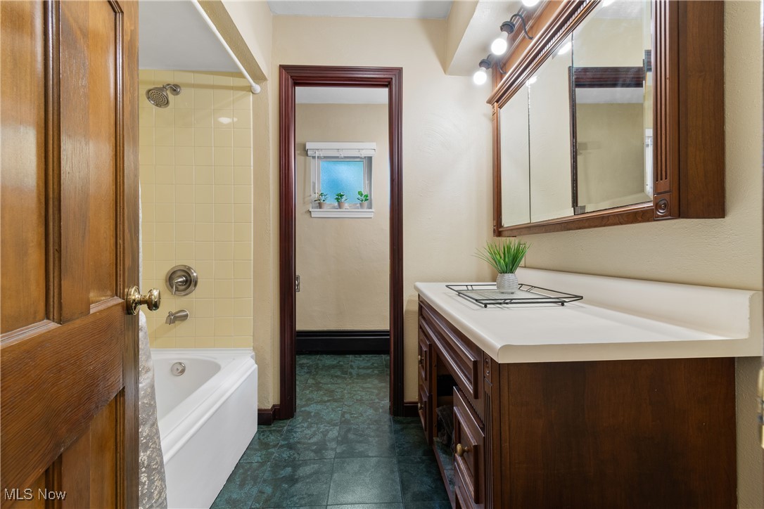 1599 Riverside Drive Akron, OH 44310 - Photo 13 of 37 Full bathroom with shower / washtub combination, vanity, and dark tile patterned flooring