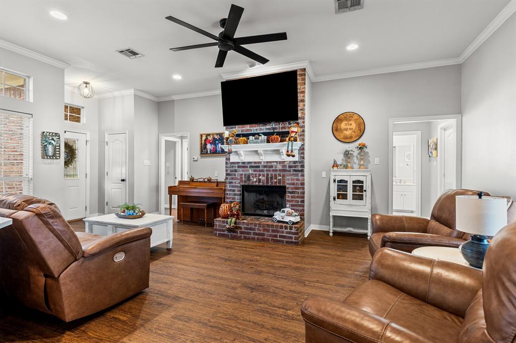 10616 Whitney Trace Drive Waco, TX 76708 - Photo 12 of 37 a living room with furniture a flat screen tv and a fireplace