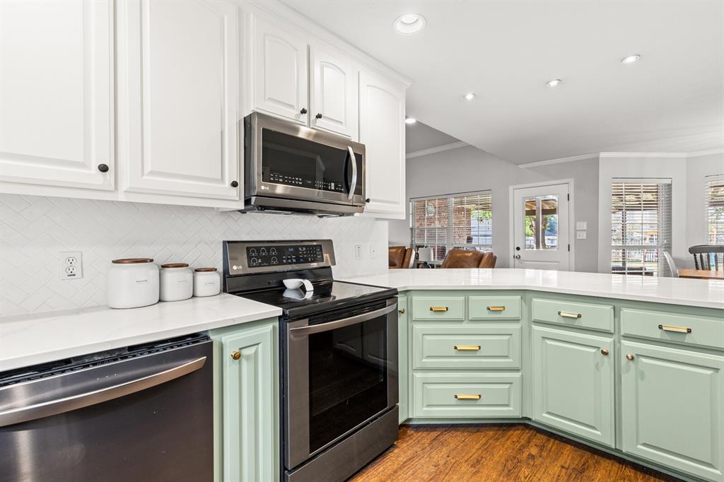 10616 Whitney Trace Drive Waco, TX 76708 - Photo 18 of 37 a kitchen with white cabinets and stainless steel appliances