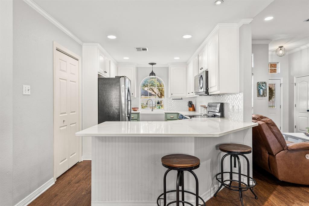 10616 Whitney Trace Drive Waco, TX 76708 - Photo 19 of 37 a kitchen with refrigerator and chairs