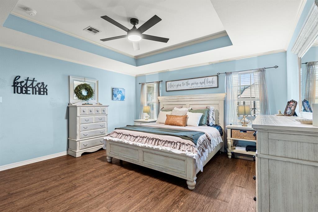 10616 Whitney Trace Drive Waco, TX 76708 - Photo 20 of 37 a bedroom with a bed and a chandelier