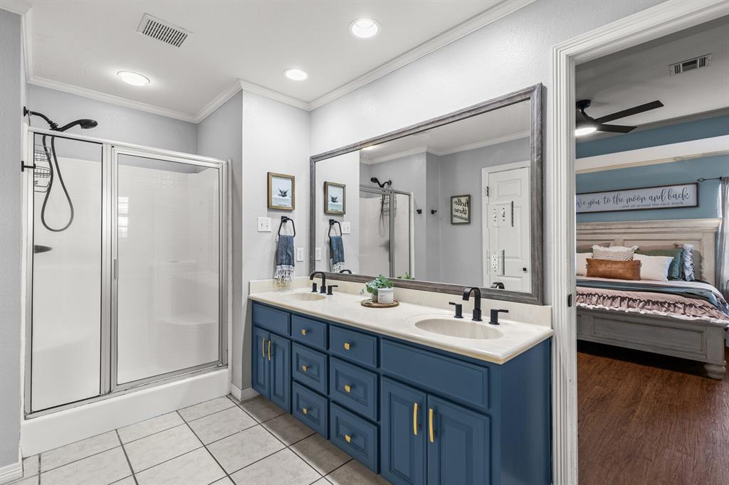 10616 Whitney Trace Drive Waco, TX 76708 - Photo 23 of 37 a bathroom with a double vanity sink a mirror and a shower