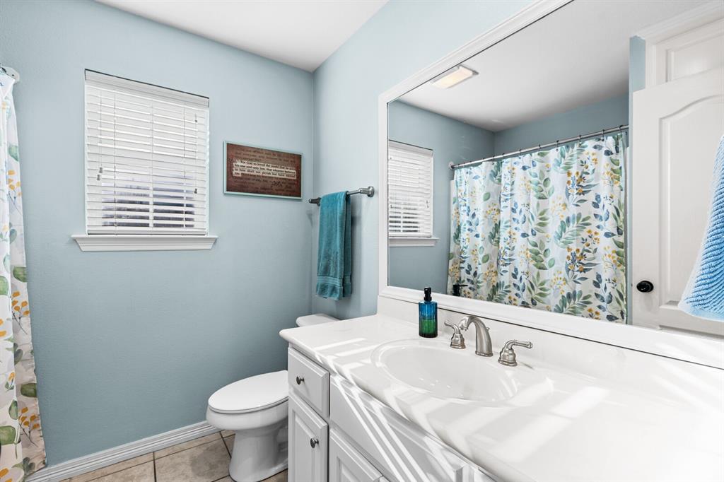 10616 Whitney Trace Drive Waco, TX 76708 - Photo 26 of 37 a bathroom with a sink toilet and window