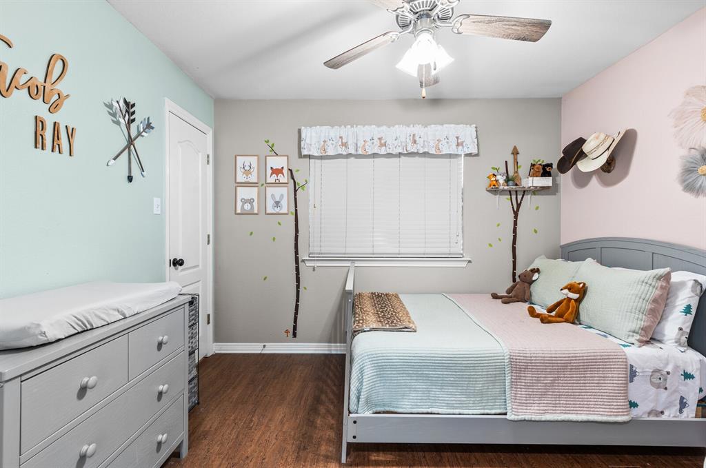 10616 Whitney Trace Drive Waco, TX 76708 - Photo 27 of 37 a bedroom with a bed and wooden floor