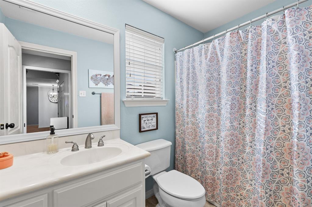 10616 Whitney Trace Drive Waco, TX 76708 - Photo 29 of 37 a bathroom with a sink a toilet and shower curtain