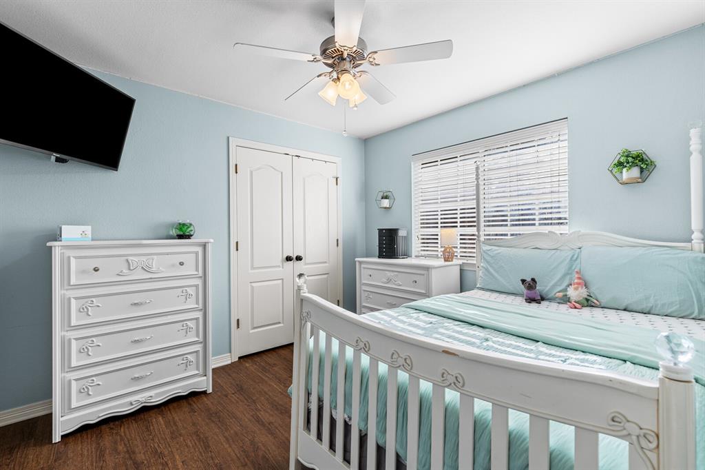 10616 Whitney Trace Drive Waco, TX 76708 - Photo 30 of 37 a bedroom with a bed and a flat screen tv