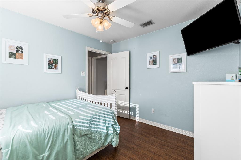 10616 Whitney Trace Drive Waco, TX 76708 - Photo 31 of 37 a bedroom with a bed and a flat screen tv